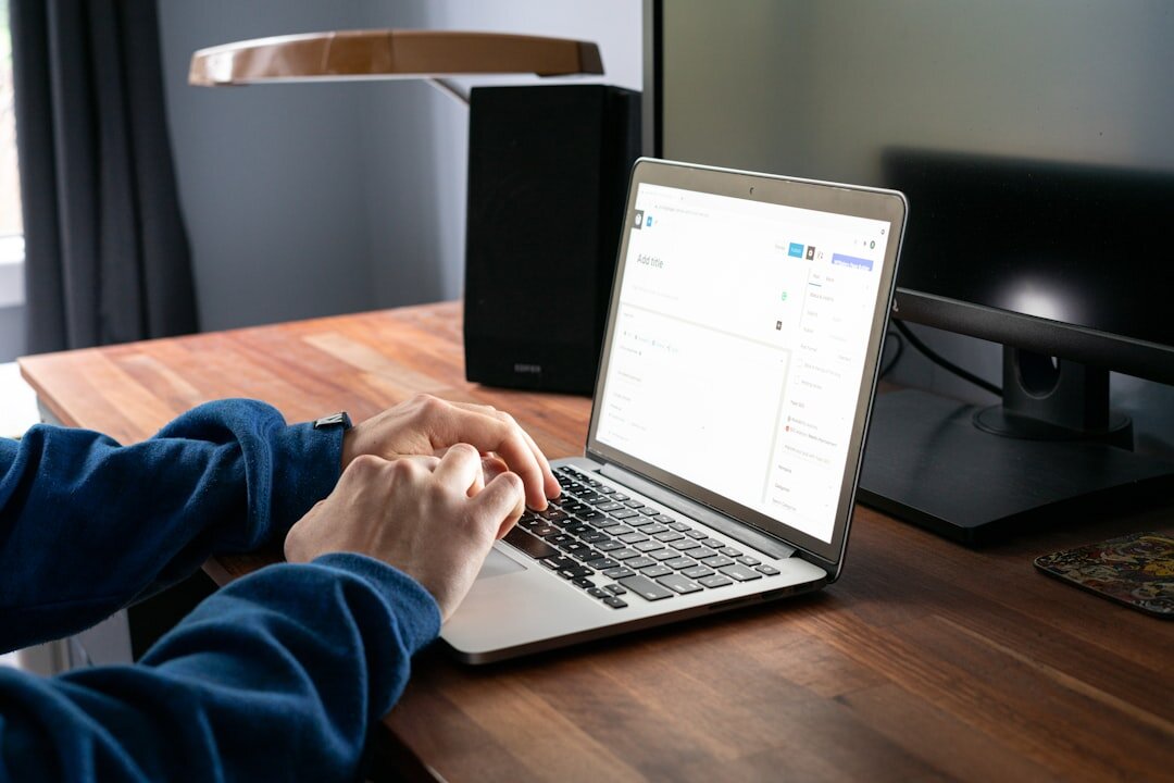 writer typing on laptop