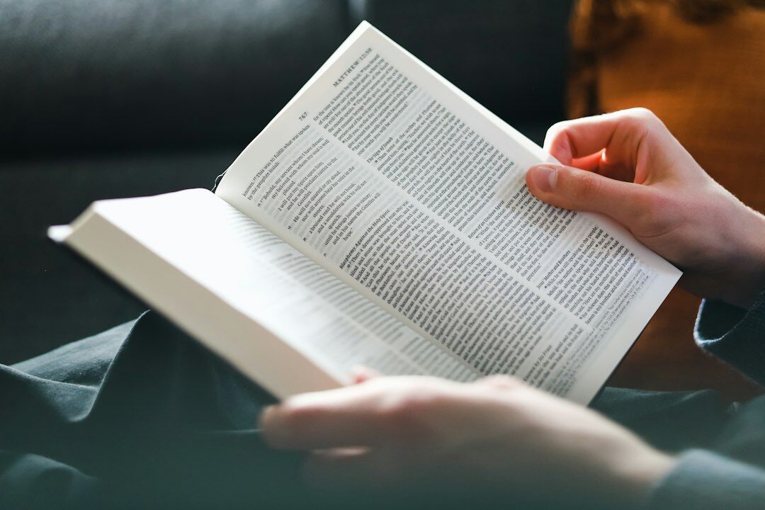person reading mystery novel at home